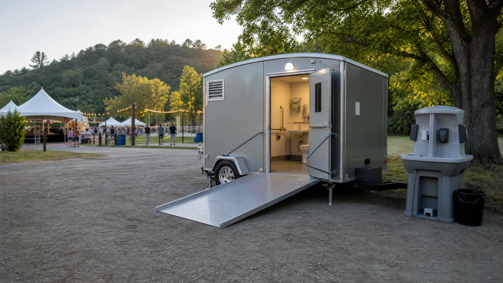 Accessible portable restroom and handwashing station at an outdoor event.